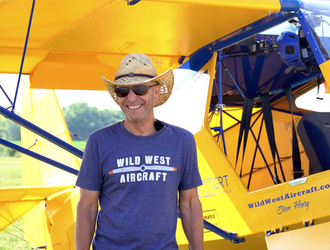 Pilot of Wild West Aircraft standing next to race plane