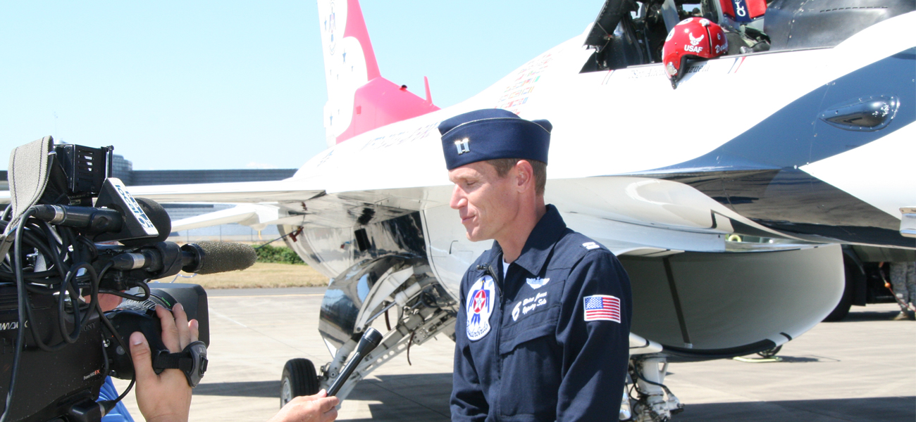 USAF Thunderbirds Pilot being interviewed by media next to show plane