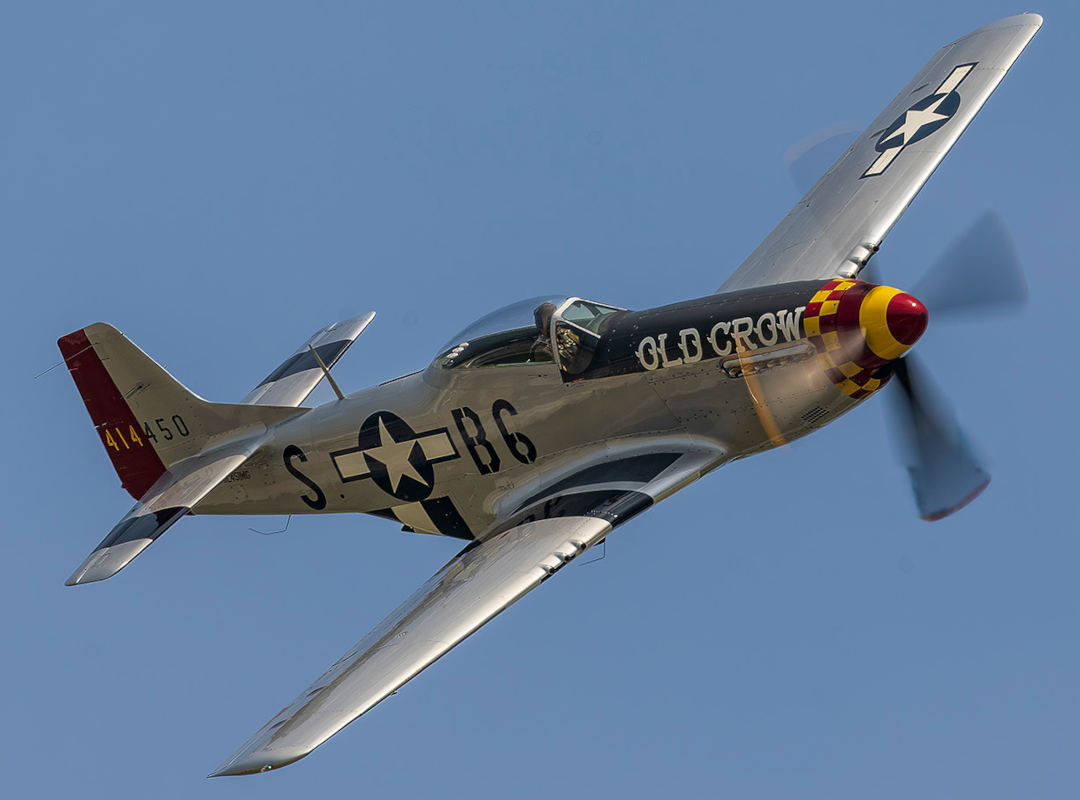 Vintage P-51 Mustang fighter aircraft painted in “Old Crow” livery flying in profile, featured as a placeholder image for the ScottsMiracle-Gro Aviation Showcase.